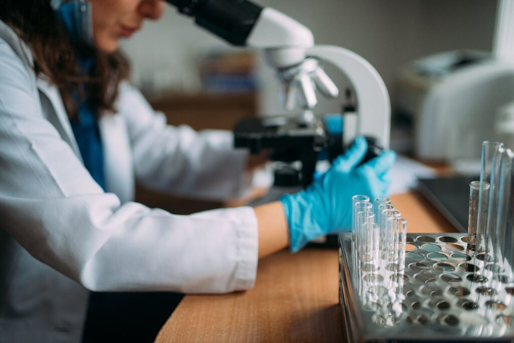 A researcher looking through a microscope in a laboratory