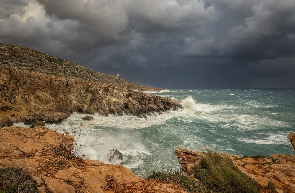 Heavy storm waves breaking against a rocky coast
