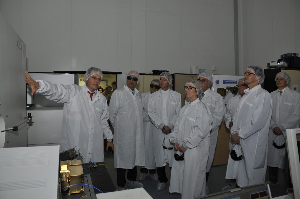 Engineers reviewing plans in front of a high technology facility
