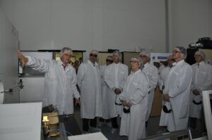 Engineers reviewing plans in front of a high technology facility