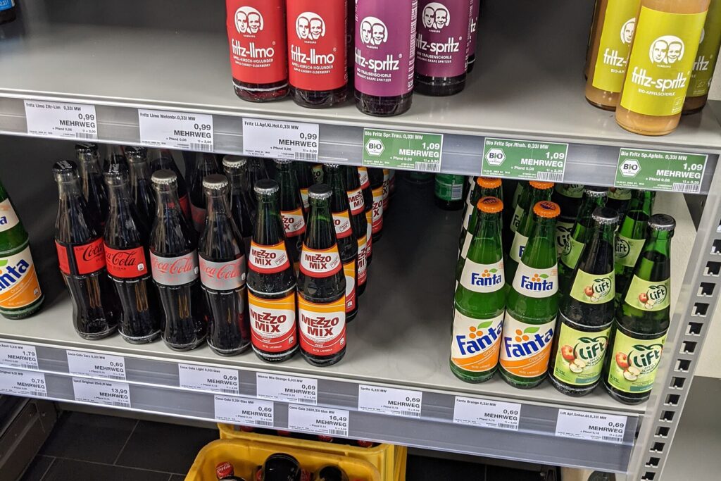 Person comparing two food products and their labels in a grocery store